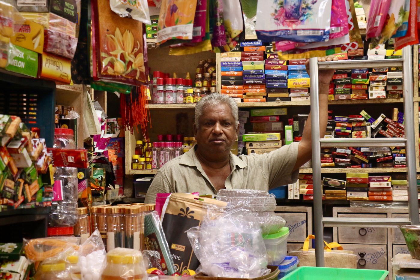 Indian shopkeeper at his store